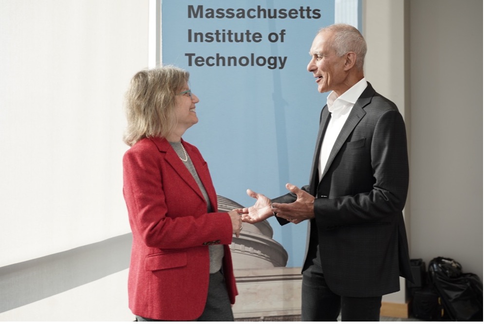 Sally Kornbluth and Moungai Bawendi stand facing each other in front of sign that says "Massachusetts Institute of Technology"