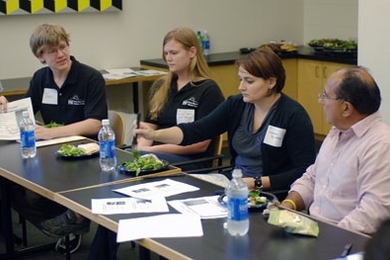 Ray Magliozzi, right, of NPR's 'Car Talk,' listens to MIT students and staff on Sept. 19. Magliozzi and his brother, Tom, who are alumni of MIT, toured the campus to see up-and-coming energy technologies being developed at the school. From left are sophomores Mike Roberts and Rachel Roberts of the MIT Solar Electric Vehicle Team, and MIT staff member Brenda Richard.