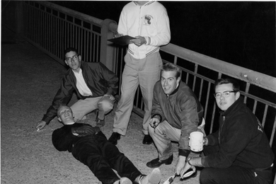 Alumnus Oliver Smoot "62 is used to measure the Massachusetts Avenue bridge in 1958.