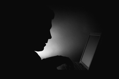 Mostly black photo showing someone's sillhouette