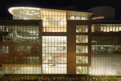 The MIT Media Lab building photographed at night, illuminated from inside.