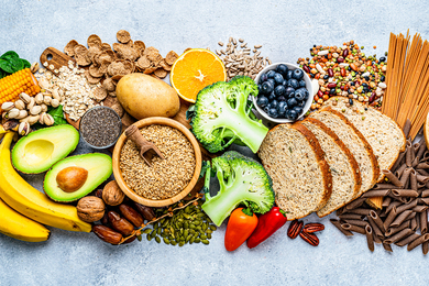 Display of healthy foods including whole grains, fruits and vegetables, and nuts