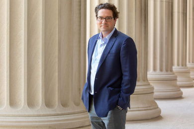 Giovanni Traverso stands outside near large MIT columns