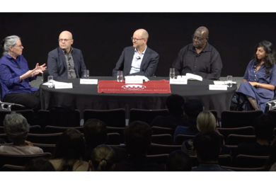 Katrina Burgess, Daniel Ziblatt, Evan Lieberman, John Githongo, and Prerna Singh sit around a long oval table in front of an audience.