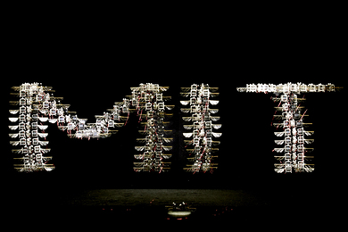 A time-lapse photo of the robotic insect’s flight path spells out “MIT.”