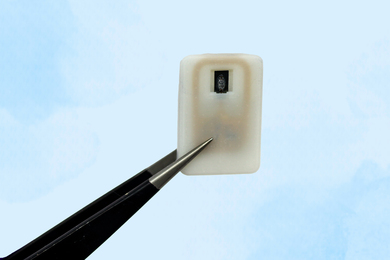 An implantable device held by tweezers