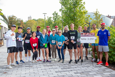 16 MIT students pose for a photo at the finish line of the DMSE 3.091 Fun Run.