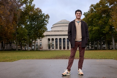 Benjamin Manning poses in front of MIT’s Great Dome and Killian Court in autumn