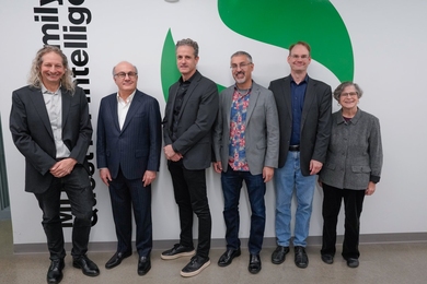 Josh Tenenbaum, David Siegel, Jim DiCarlo, Nick Roy, Erik Vogan, and Leslie Kaelbling stand along an indoor wall