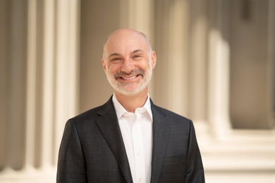 Agustín Rayo posing with columns of an MIT building in the background