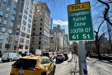 A NYC sign says, “Toll; congestion Relief Zone south of 61st street.”