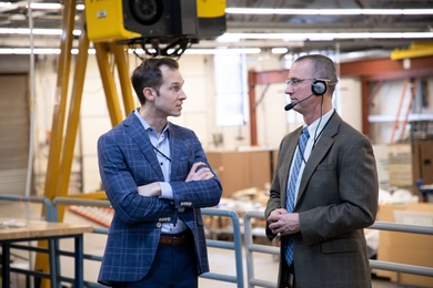 Jake Auchincloss and Steve Wukitch speak to each other in a nuclear fusion lab