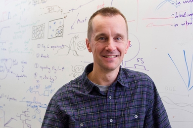 Headshot of Michael Laub in front of a whiteboard