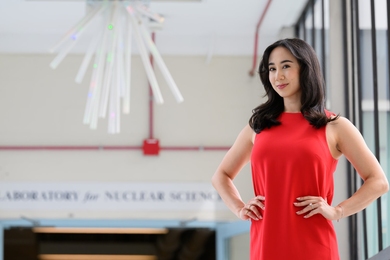 Jessica Fry stands in the bright atrium of the LNS