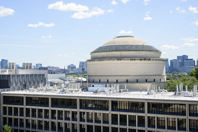 MIT’s Great Dome rises behind the Vannevar Bush Building on a sunny day