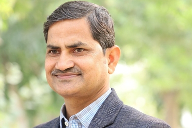 Headshot of Mohammad Imran Khan Mewati with trees in background
