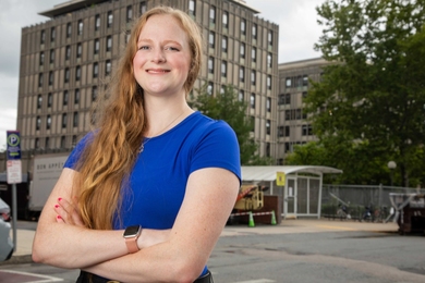 Sydney Baller poses in front of MIT's McCormick Hall 