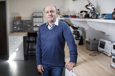 Photo of David Siegel standing in a robotics lab