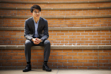 Naoki Egami sits on amphitheater stairs