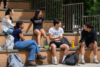 A group of MIT students sitting together and smiling