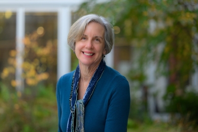 Portrait of Suzy Nelson in a courtyard on an early fall day