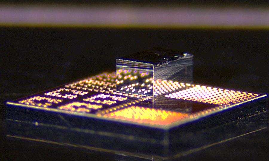 Closeup of unique chip with tiny shiny box on top.