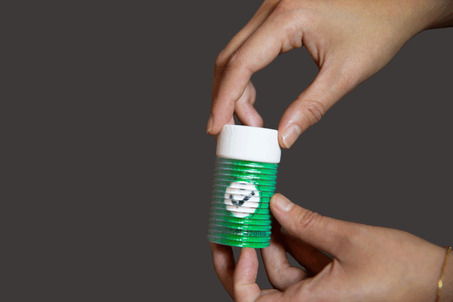 A chemical bottle that changes color when the cap is on or off