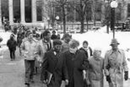 Paul Gray (first row, second from left), one of the winners of this year's        MLK Leadership Award, walks in a procession during the 1984 celebration        of Dr. Martin Luther King Jr. On Gray's right is keynote speaker John        R. Bryant, pastor of St. Paul's AME Church in Cambridge.