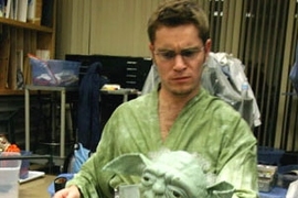 Kenneth Kamrin, a graduate student in mathematics, works with the Yoda puppet, one of the stars of 'Star Wars Trilogy: Musical Edition,' a production of the MIT Theater Guild.