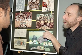 Scot Osterweil, creative director of the CMS Education Arcade, shows freshman Paul Medlock-Walton a game designed to teach math and literacy to middle school students.