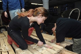 Students from Professor of Archeology and Ancient Technology Dorothy Hosler's class work on making  the full-size authentic replica of a pre-Columbian South American balsa oceangoing raft on the Charles river. Here Leslie Dewan and Feng Wu work.