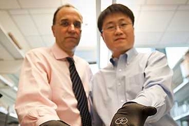 Michael Cima, left, and Heejin Lee SM ’04, PhD ’09 display the drug-delivery devices they developed to help treat interstitial cystitis. Cima holds the device built for humans; Lee's is sized for a rabbit.