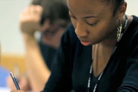 A student writes while at desk