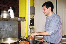 Benjamin Francis, and MIT junior, prepares dinner at the soup kitchen he started to help the homeless.