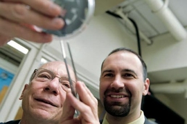 Joel Schindall of electrical engineering and computer science (left) and Riccardo Signorelli PhD ’09 of FastCAP Systems examine carbon-nanotube-coated samples that proved key to the development of the full-scale, high-performance ultracapacitors now being marketed by FastCAP.