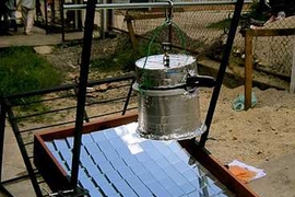 The SolarClave system at work. The sterilizing vessel is an ordinary pressure cooker that has been insulated on the top and sides.
