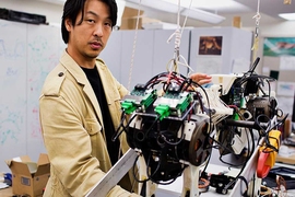 Assistant Professor Sangbae Kim demonstrates the 70-pound 'cheetah' robot designed at MIT.