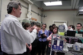 Michael Rubner explains his lab's research into layer-by-layer deposition of polymers that create color by selective composition of materials, much like a butterfly's wing, to a group of Summer Scholars.