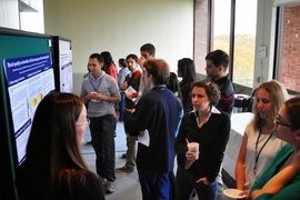 At the 2013 GCC Poster Session, PAOC&#39;s Rebecca Saari (left) presents her research on climate change policy. 