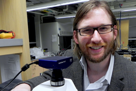 Visiting graduate student Ryan Oliver with a microscope. Oliver's projects under associate professor of mechanical engineering A. John Hart include the Robofurnace, an automated system for making carbon nanotube forests and studying their growth, and high-throughput manufacturing of polymer microstructures for biosensing.