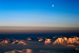 An aerial view of clouds over a mountain range in Greenland. 