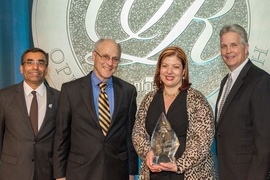 MIT LGO’s Georgia Perakis holds the UPS George D. Smith Prize trophy, alongside LGO program director Don Rosenfield (to her right). With them are Ranganath Nuggehalli, chair of the 2014 UPS George D. Smith Prize Committee (far left), and Randy Stashick, global vice president of engineering for UPS (far right).