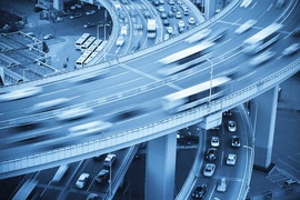 Motion blur photography of cars in traffic on highway bridge