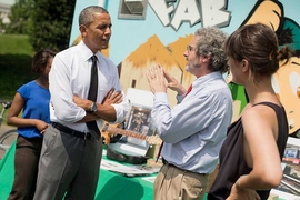 President Barack Obama talks with Neil Gershenfeld, director of MIT’s Center for Bits and Atoms, as MIT graduate student Nadya Peek, right, looks on, during this week's White House Maker Faire. MIT's Mobile Fab Lab can be seen in the background.