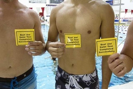MIT students hold evidence of swim-test success.