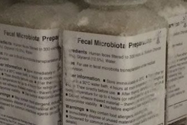 5 labeled bottles of fecal microbiota preparate show lists of text.