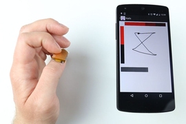 A new wearable device, NailO, turns the user’s thumbnail into a miniature wireless track pad. Here, it works as a X-Y coordinate touch pad for a smartphone.