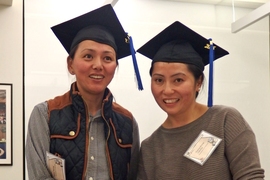 Dolma Tsering (left) and Tsering Mulug-Labrang celebrate after earning their high school diplomas thanks to MIT’s ESL Program for Service Employees.