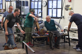 Lino Tagliapietra and his team work on a large multi-colored vessel in the MIT Glass Lab.