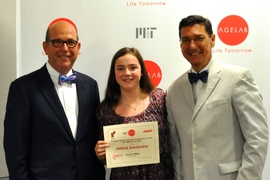MIT AgeLab's Joe Coughlin (left) and AARP's Michael E. Festa (right) present the inaugural OMEGA award to Lauren Miller.